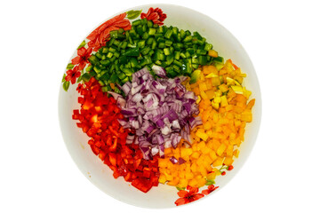 egetable salad. Arrangement on plate with onion, corn, mango, tomato, green pepper and red pepper. White background. Horizontal.