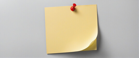  Blank yellow sticky note pinned to bulletin board in office 