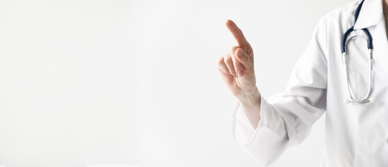 a doctor in a white coat with stethoscopes on a white background points with his finger at a future...