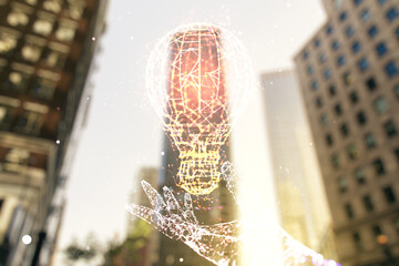 Abstract virtual light bulb hologram on blurry cityscape background, idea concept. Multiexposure