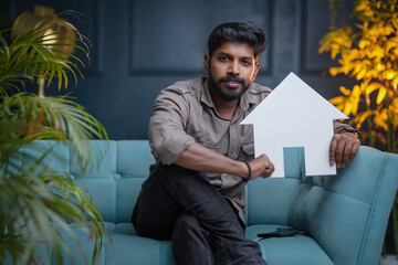 Indian man holding house image, Home loan and Real Estate business concept photo