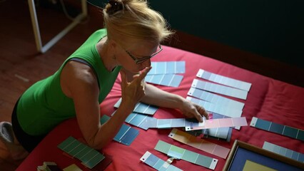 Mature woman thinking about paint colors for home renovation remodeling project