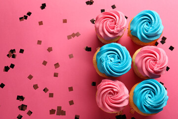 Delicious cupcakes with bright cream and confetti on pink background, flat lay. Space for text