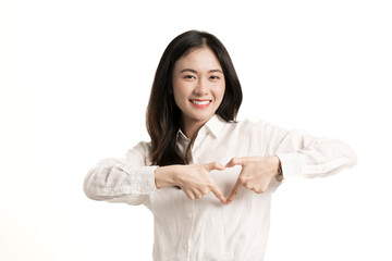 Portrait young Asian woman feels happy and romantic shapes heart gesture expresses tender feelings wear white shirt isolate on white background.Hands making sign heart by fingers with copy space.