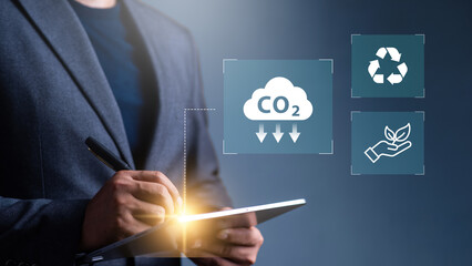 Reduce co2 emission. man using software to lower CO2 emissions to limit global warming and climate...
