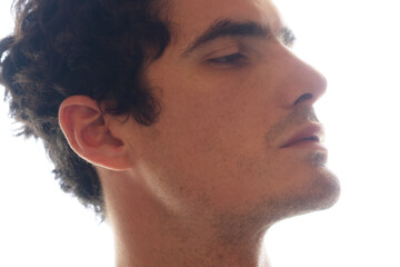 A profile portrait of a young man with his chin up