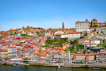 A photograph of the city of Porto intended for tourism on a sunny day. Concept: A city with traditional Portuguese architecture on the banks of the Douro River.