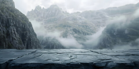 Cool slate surface with a soft-focus backdrop of misty mountains, suitable for hiking gear or outdoor adventure products