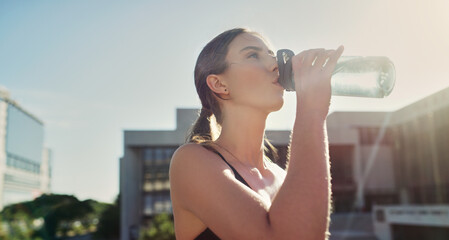 Healthy, woman or athlete in city drinking water for break, workout and training for marathon....