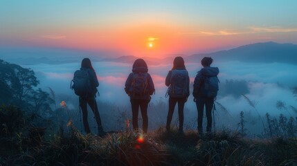A group of young female backpackers happily look at the mist and the morning sun as the travelers soak up the beauty of the mountain nature landscape during their holiday trip. Very happy