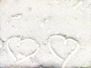 Heart on snow. Hearts traced on a white blanket of snow. Background, texture. Valentine's day