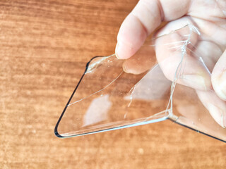 Removing Protective Film From a Cracked Screen. Peeling off a cracked screen protector from a phone