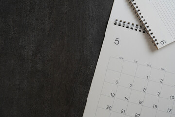 close up of calendar on the black table background, planning for business meeting or travel...