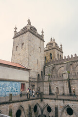 The inner courtyard of the cathedral of Porto, showcasing a prominent monument in the center,...
