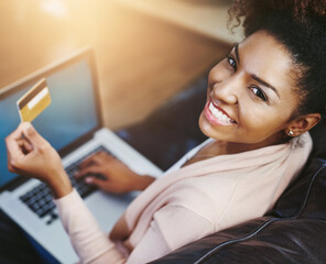 Credit card, laptop and portrait of black woman on sofa for online shopping, internet purchase or...