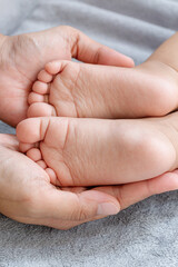Baby feet,Parents hold in the hands and feet of the newborn baby. 