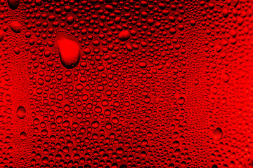 Close-up of water drop surface on red drink glass,Red close-up macro drink water drop surface,Water droplets on a glass of red cold drink for background and texture