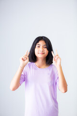 Smiling young Asian woman in casual outfit pointing away,Young Asian woman with short hair isolated on white background