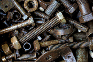 Pile of rustic nuts and bolts in grease,Close-up of a nut with oil stains,