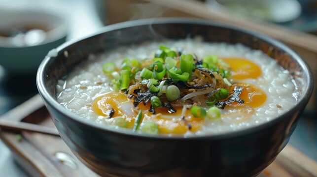 A traditional Chinese congee breakfast topped with century eggs and scallions