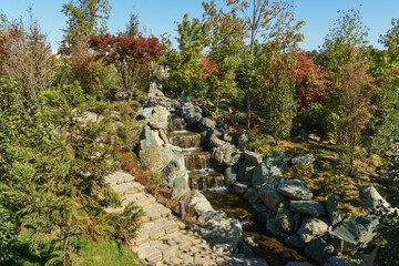 Cascading waterfall in Japanese garden of public landscape park of Krasnodar or Galitsky  park, Russia