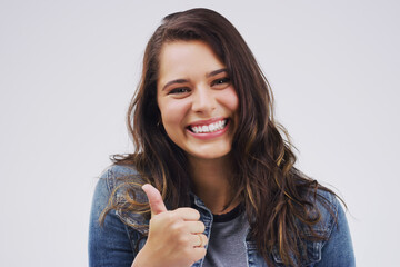 Happy, portrait and girl with thumbs up support in studio for thank you, congratulations or praise...