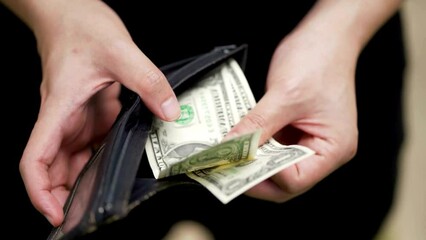 Close up poor human hand holding old wallet with less money, financial crisis