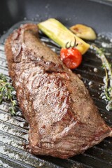 Delicious grilled beef meat and vegetables in pan, closeup