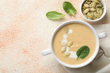 Healthy cream soup high in vegetable fats on color textured table, flat lay. Space for text
