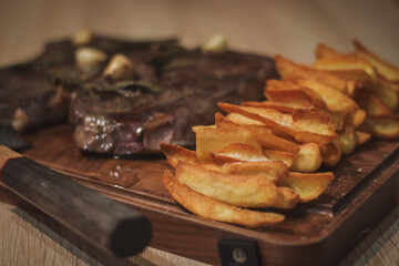 beef steak sous vide with potato dippers, rosemary and garlic, home cooked dish