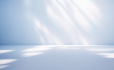 Light blue minimalistic background for product presentation with beautiful light and shadow on the wall and floor.