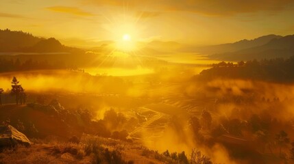 The sun rising over a misty valley, casting a golden glow over the landscape
