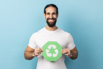 Portrait of smiling man with beard wearing white T-shirt showing green waste recycling symbol,...