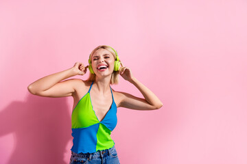 Portrait of crazy satisfied woman with bob hair wear colorful top touch headphones sing favorite...