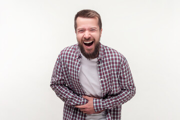 Portrait of funny happy bearded man laughing out loud holding his belly being festive good mood,...