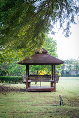 A wooden pavilion in the middle of the garden
