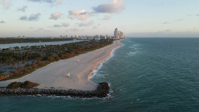Aerial scenery of Haulover beach landscape with skyline in the background at sunset in Florida, USA