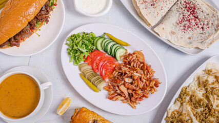 Chicken portion doner kebab plate, lentil soup, gutab, khangal top view	