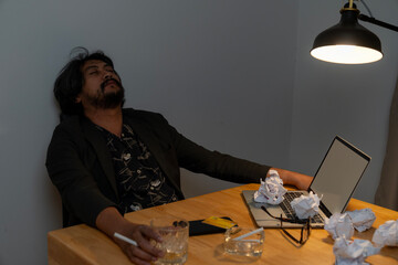 The businessman has failed in his work and is drinking alcohol