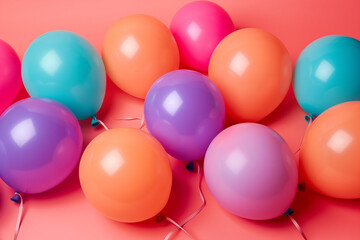 Group of colorful festive matte balloons on pink pastel background.