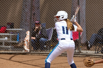 Young Female fastpitch softball player playing club sports.