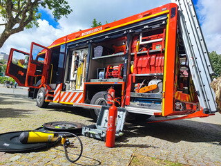 Fire truck with open doors on a sunny day. Firefighting equipment for saving lives and emergency...
