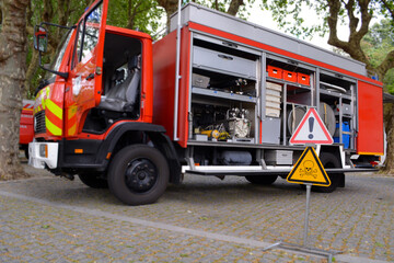Fototapeta premium Fire truck with open doors on a sunny day. Firefighting equipment for saving lives and emergency situations