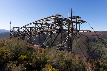 Metal structure tower with concrete base from coal mine cable cart industrial abandoned cableway on...