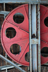 Steel metal wheel in industrial coal mining factory building with beams in Tormaleo Asturias.
