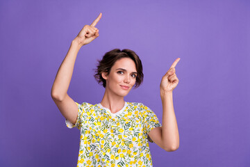 Photo of adorable nice girl wear stylish clothes recommend empty space poster promo isolated on purple color background
