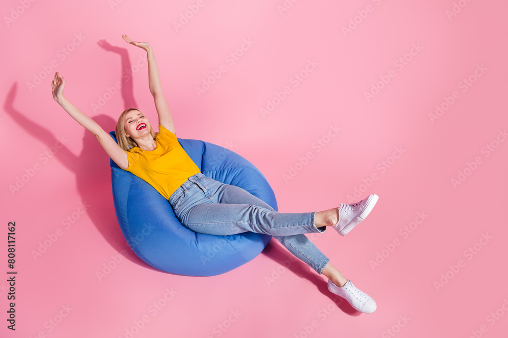 Sticker full length photo of funky carefree woman wear yellow t-shirt relaxing bean bag empty space isolated