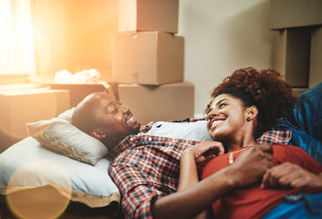 Black couple, relax and happy on floor of new house with bonding, support and break from moving....