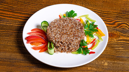 Buckwheat dish with vegetables on plate
