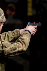 close up of a military trainer taking aim for shot at a professional shooting range